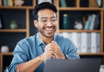 Man at a computer with headphones
