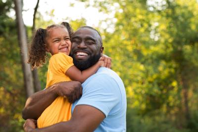 Man holding and hugging child