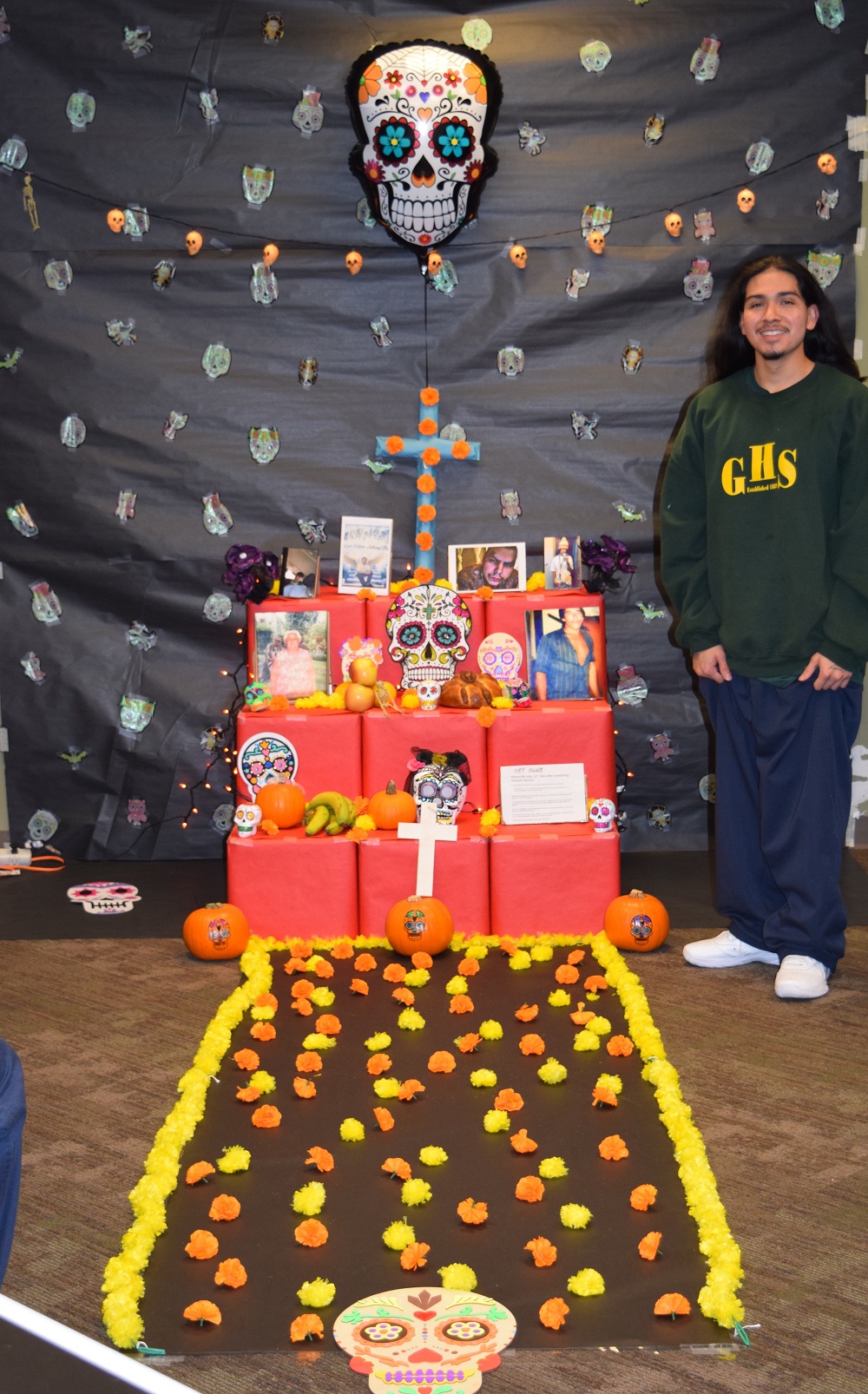 Alexis standing next to the ofrenda in his living unit at Green Hill School 