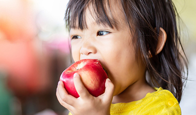 child eating apple