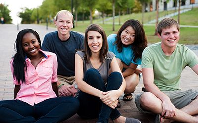 group of teens sitting outside