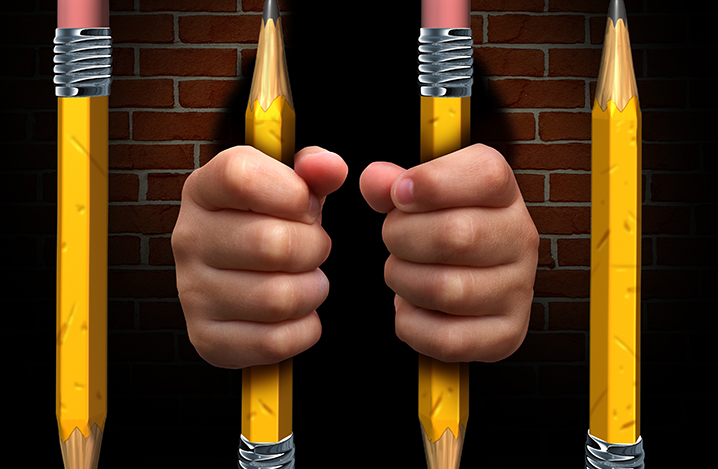 hands holding pencil jail bars