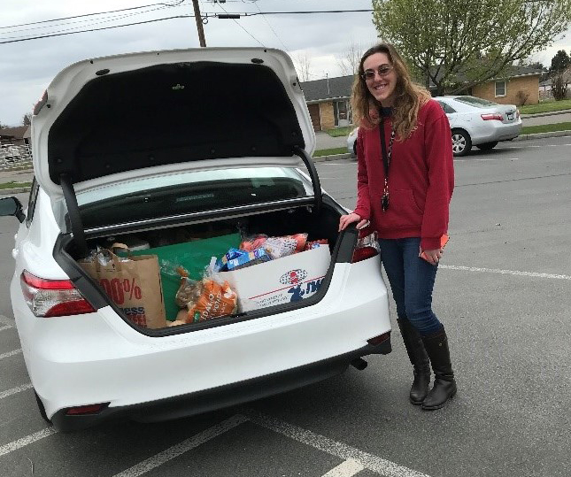 An ECEAP teacher in Prescott, WA showing food delivery items for ECEAP families.