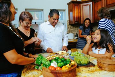 Family in kitchen preparing food