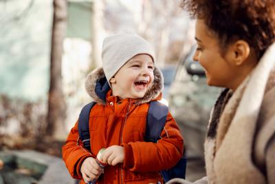 Small child smiling at an adult woman