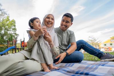 Happy Muslim family have at an outdoor picnic