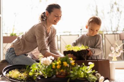 Mother and daughter planiting flowers