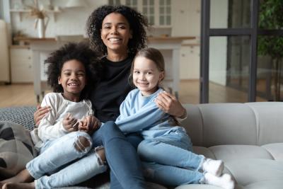 Portrait of smiling African American mother hugging children