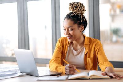 Woman working and smiling at computer
