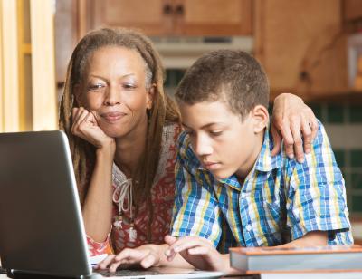 Caregiver and youth at computer.