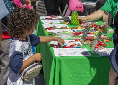 child at a booth getting candy