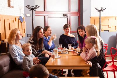 Adults and toddlers at meeting in a coffee shop