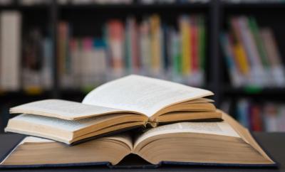 Open books on a desk in a library