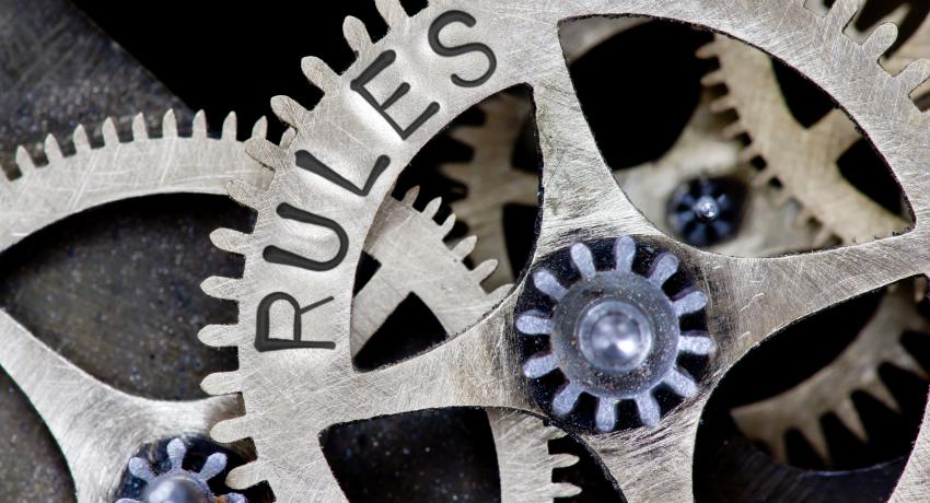 Image of gears with the word rules written on them