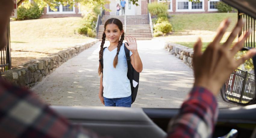 Stock image of child getting dropped off.