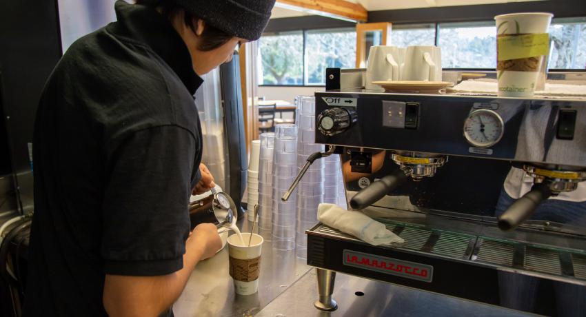 youth pouring coffee