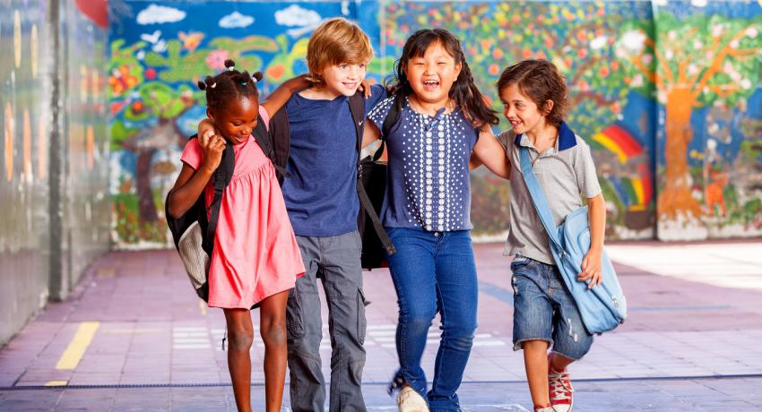 Smiling children arm in arm. 