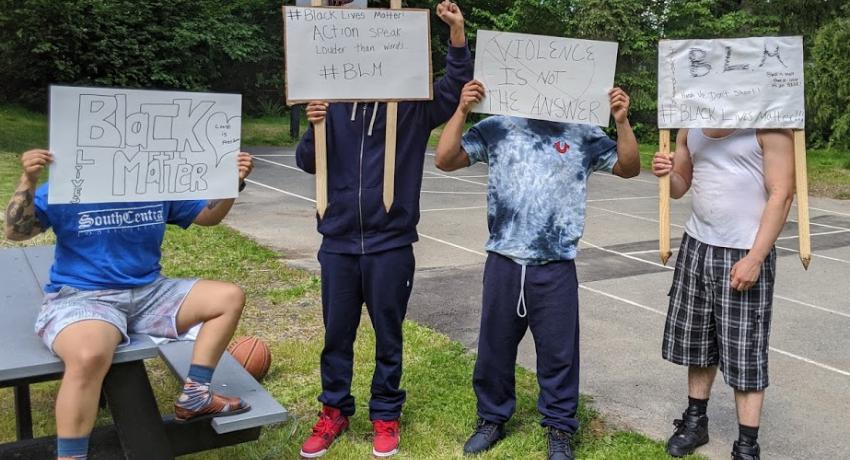 Youth hold Black Lives Matter posters.