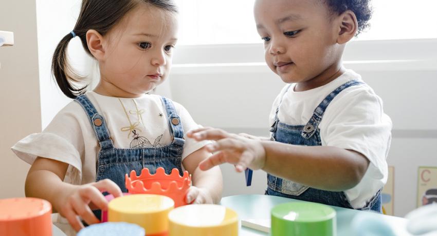 Little kids playing toys at learning center