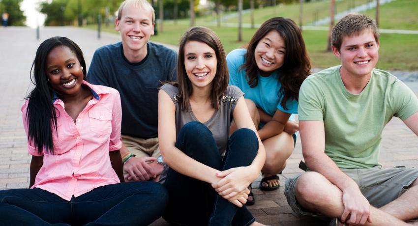 A group of young people hanging out in the park. 