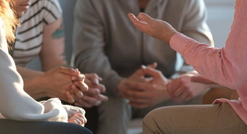 Young people gathering for a discussion with an adult. 