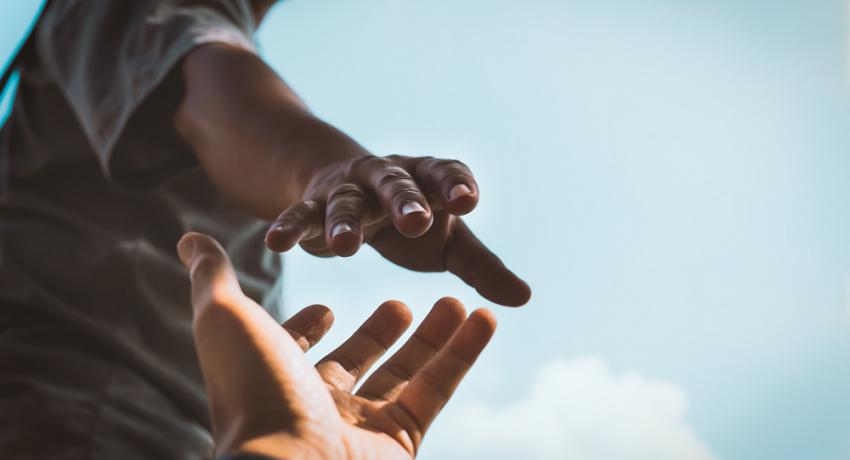 Two hands reaching out for each other. 