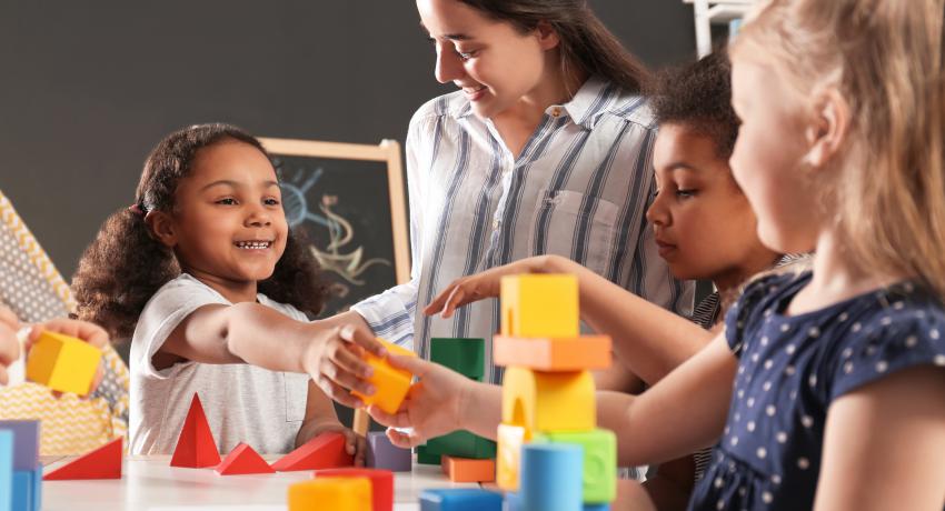 early learning teacher with young kids