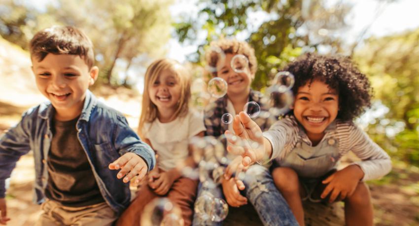 Diverse children laughing, smiling and being happy.