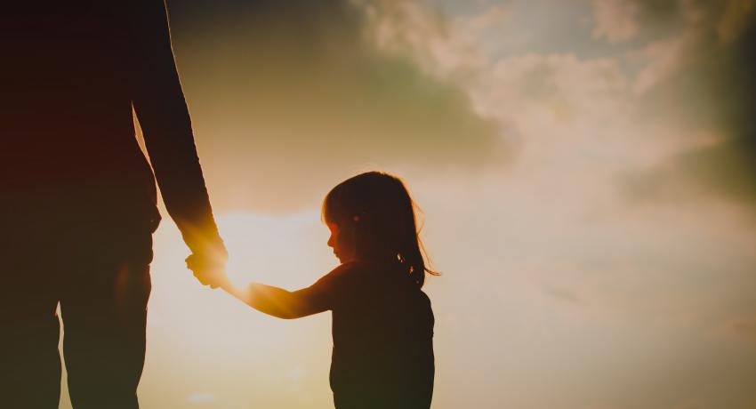 Daughter holding dad's hand