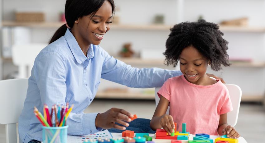 Early learning teacher with child