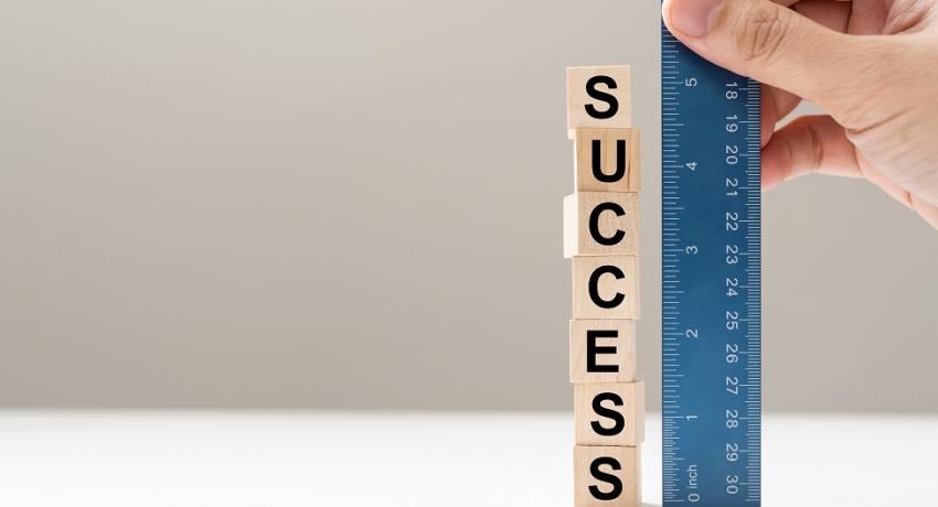 Measuring stick saying "Success"