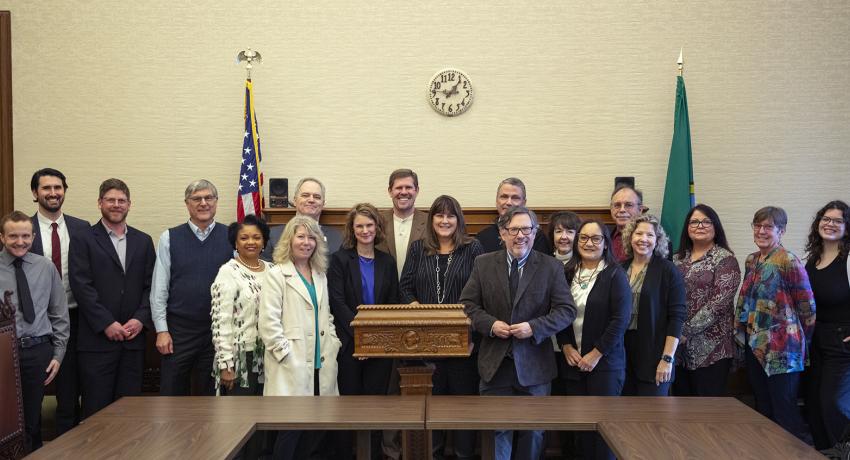 DCYF Secretary Ross Hunter, DCYF staff, and folks from the public housing authority and housing non-profits came together on Feb. 15 in Olympia to sign an agreement to provide housing vouchers to child welfare-involved families and youth.