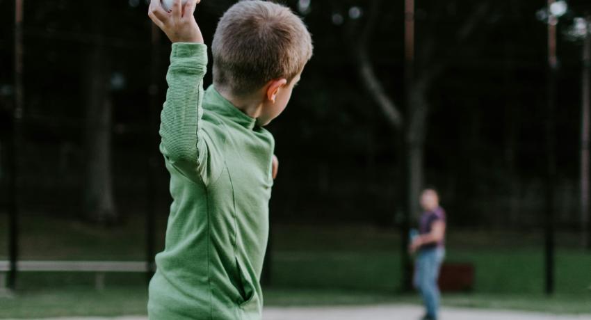 kids throwing baseball outside to a person who is far away