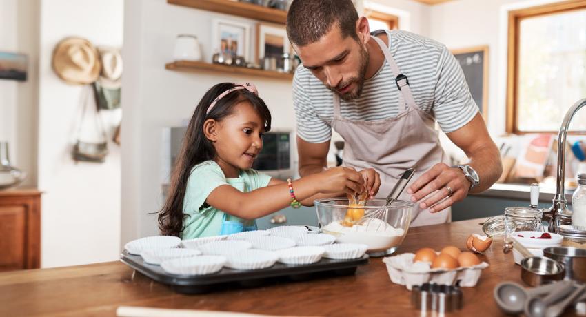 dad and daughter cooking in the kitchen