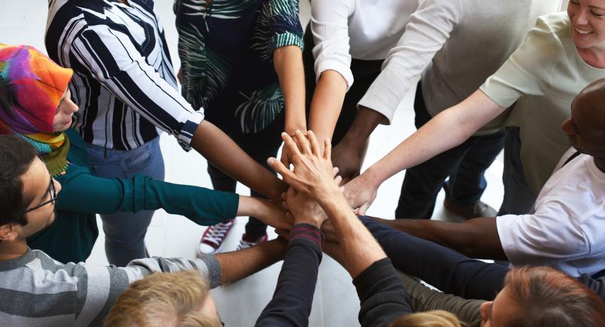 Hands coming together in a circle