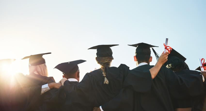 Young people in graduation caps 