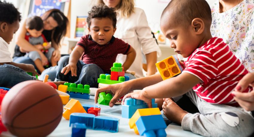 children and teachers in a classroom. 