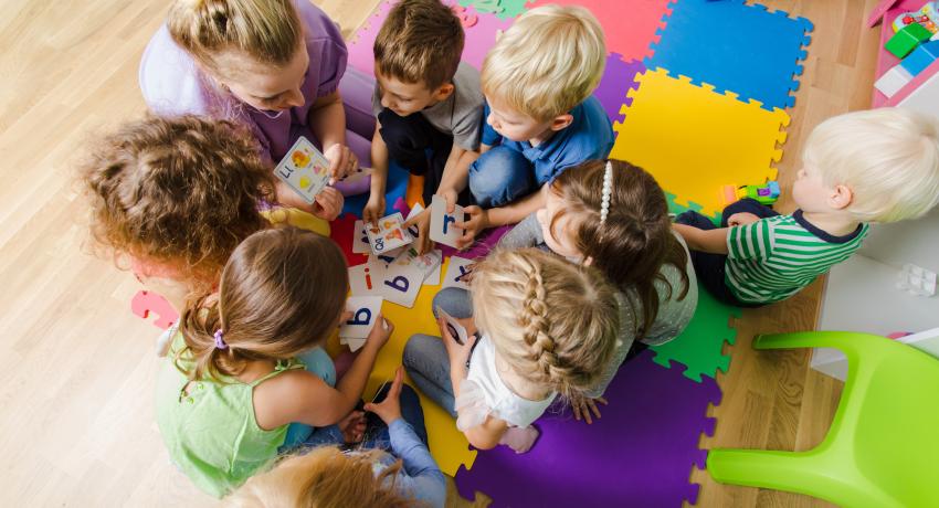 Children playing together in classroom.