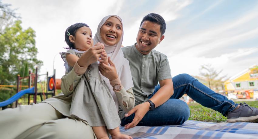 Happy Muslim family have at an outdoor picnic