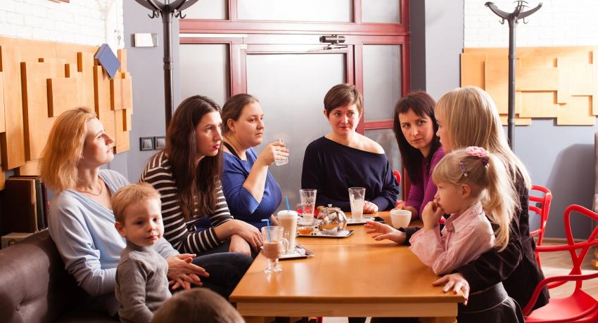 Adults and toddlers at meeting in a coffee shop